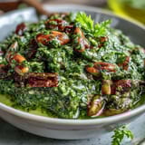 Vibrant dandelion pesto featuring fresh greens, garlic, and toasted pine nuts, ideal for sandwiches or roasted vegetables.