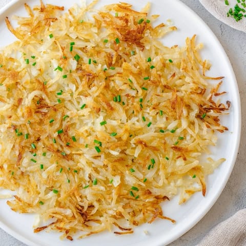 Imagine perfectly fried hash browns, with crunchy edges and a fluffy interior, ready to eat.