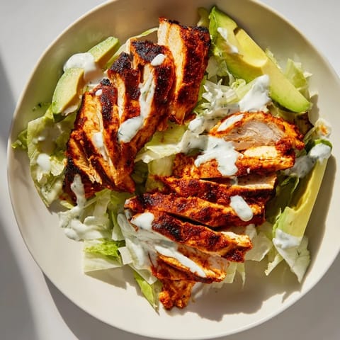 A close-up of smoky chipotle chicken wraps with fresh diced tomatoes and thin red onion rings, ready to serve on a rustic wooden board for an easy weeknight meal.