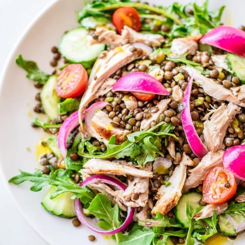 Golden-brown roasted chicken and tender green lentils nestle among peppery arugula in this vibrant Lentil & Chicken Spring Salad.