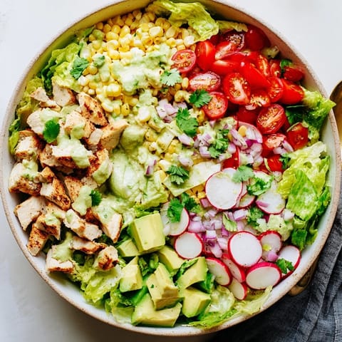 Juicy diced avocado, crisp radishes, and cherry tomatoes tossed in zesty lime dressing for the Roasted Corn & Chicken Chopped Salad.  