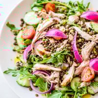 Golden-brown roasted chicken and tender green lentils nestle among peppery arugula in this vibrant Lentil & Chicken Spring Salad.